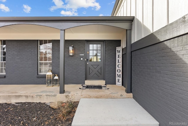 doorway to property with brick siding