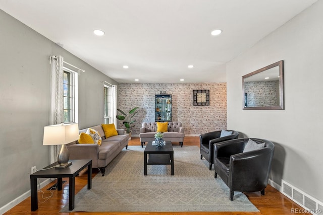 living area with recessed lighting, light wood-style floors, visible vents, and baseboards