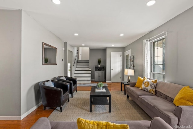 living area featuring recessed lighting, stairs, baseboards, and wood finished floors