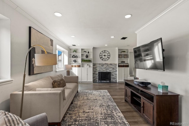 living room with dark wood-style floors, recessed lighting, a fireplace, and crown molding