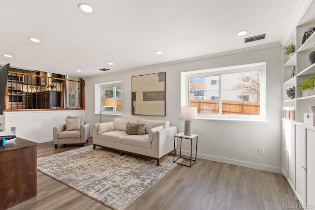 living room with visible vents, recessed lighting, wood finished floors, and baseboards