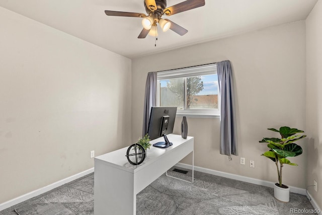 carpeted office space featuring visible vents, baseboards, and ceiling fan