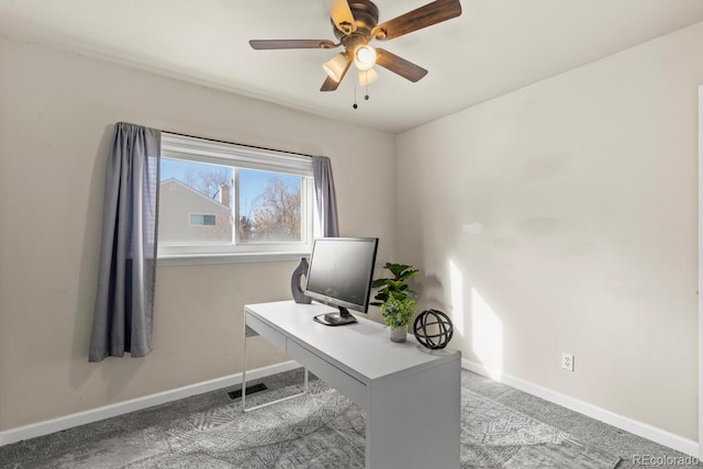 carpeted home office with visible vents, baseboards, and a ceiling fan