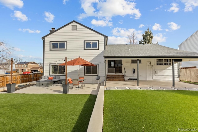 rear view of property with a patio area, a yard, and fence