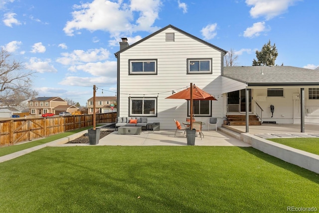 rear view of property featuring a patio, fence, a chimney, entry steps, and a lawn