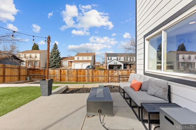 view of patio / terrace featuring an outdoor living space, a fenced backyard, and a residential view