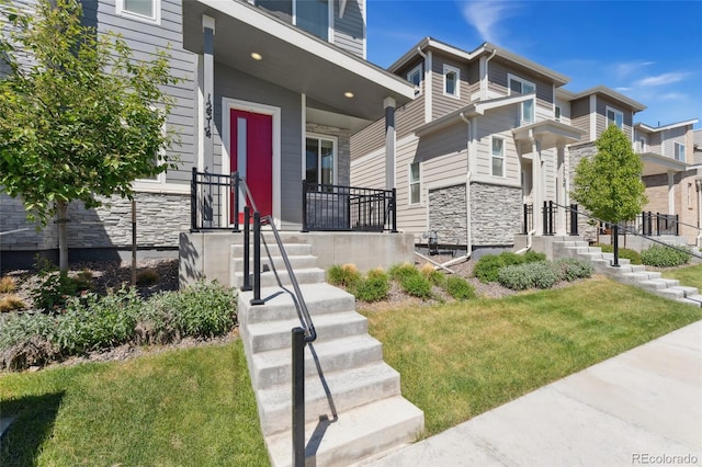 exterior space with stone siding, a porch, and a yard