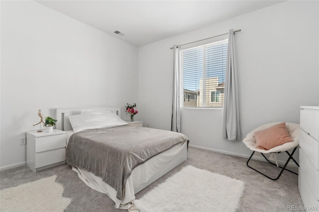bedroom featuring light colored carpet, baseboards, and visible vents