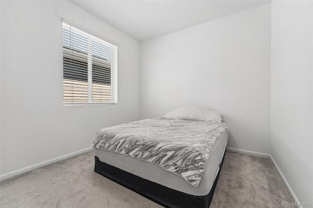 carpeted bedroom featuring baseboards