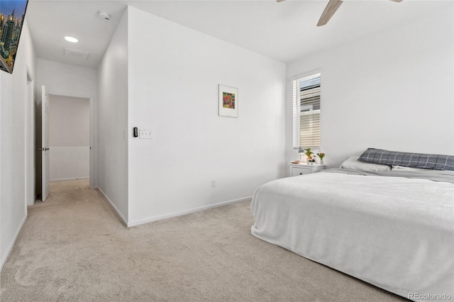 bedroom featuring light colored carpet, baseboards, a ceiling fan, and visible vents