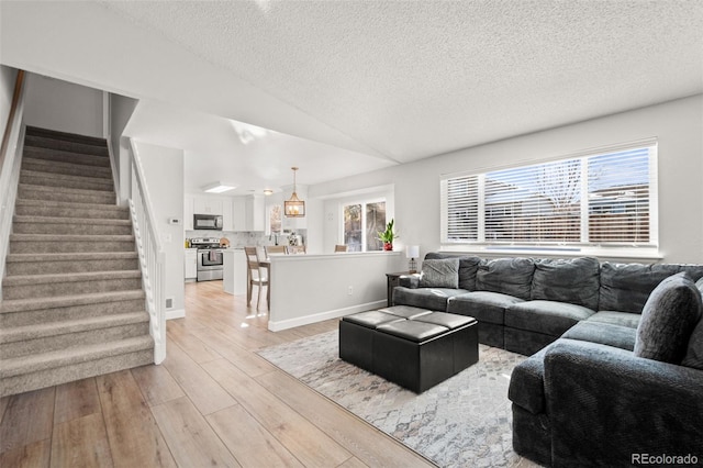 living room featuring plenty of natural light and a textured ceiling