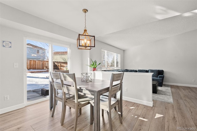 dining room featuring light hardwood / wood-style flooring and a notable chandelier