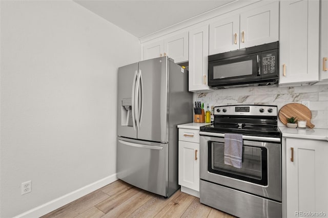 kitchen with white cabinets, light wood-type flooring, backsplash, and appliances with stainless steel finishes