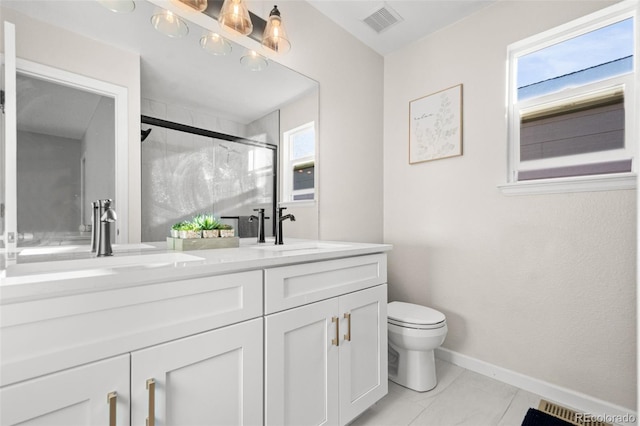 bathroom with vanity, toilet, and a shower with door