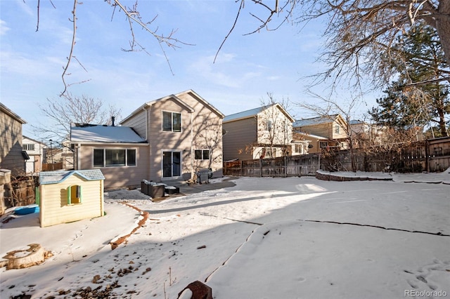 view of snow covered back of property