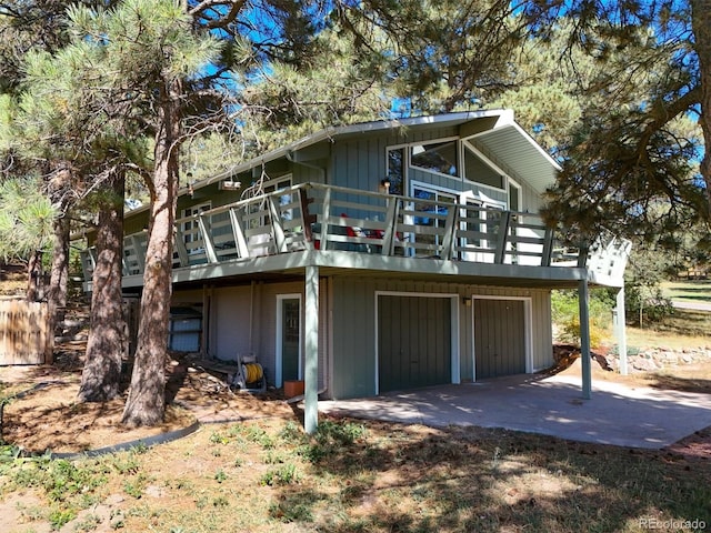 exterior space with a garage and a wooden deck