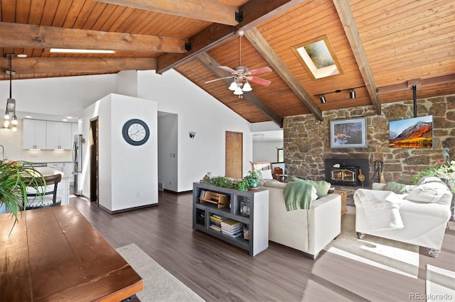 living room with high vaulted ceiling, dark wood-type flooring, a skylight, wooden ceiling, and ceiling fan