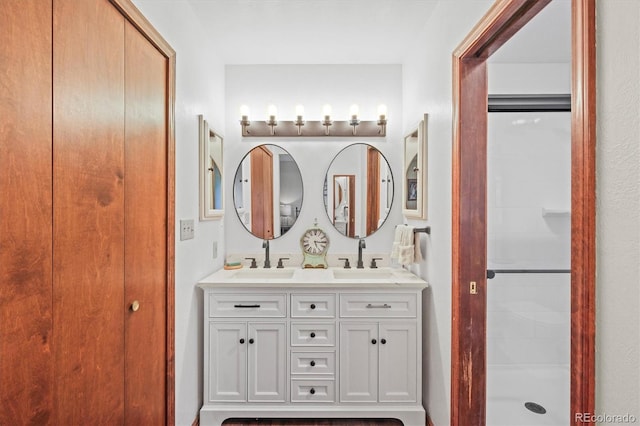 bathroom featuring walk in shower and vanity