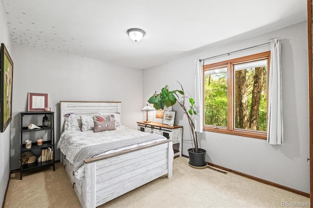 bedroom featuring light carpet