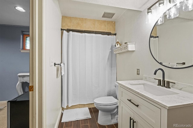 bathroom featuring a shower with shower curtain, hardwood / wood-style flooring, vanity, and toilet