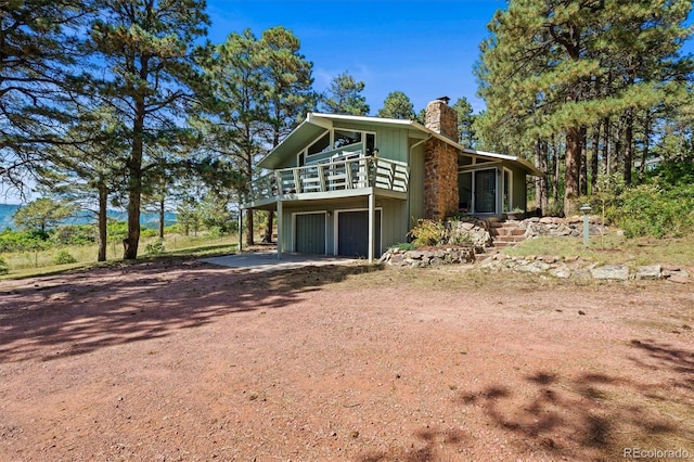 view of front of home featuring a garage and a wooden deck