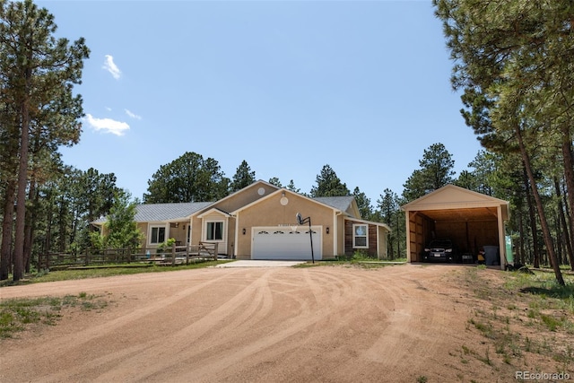 11030 Pine Meadows Rd, Colorado Springs, CO 80908 - ranch-style home featuring driveway, a carport, a garage, and stucco siding
