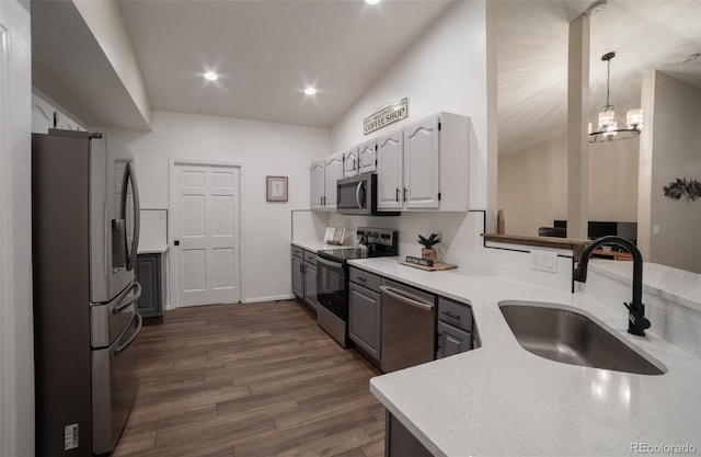 11030 Pine Meadows Rd, Colorado Springs, CO 80908 - kitchen featuring stainless steel appliances, dark wood-style floors, hanging light fixtures, light stone countertops, and recessed lighting