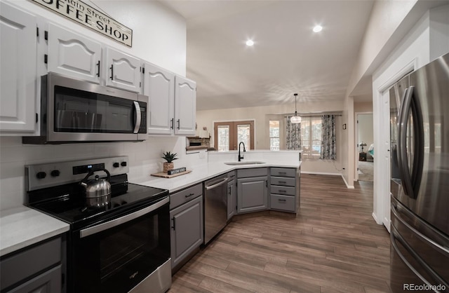 11030 Pine Meadows Rd, Colorado Springs, CO 80908 - kitchen with appliances with stainless steel finishes, gray cabinets, a peninsula, backsplash, and recessed lighting