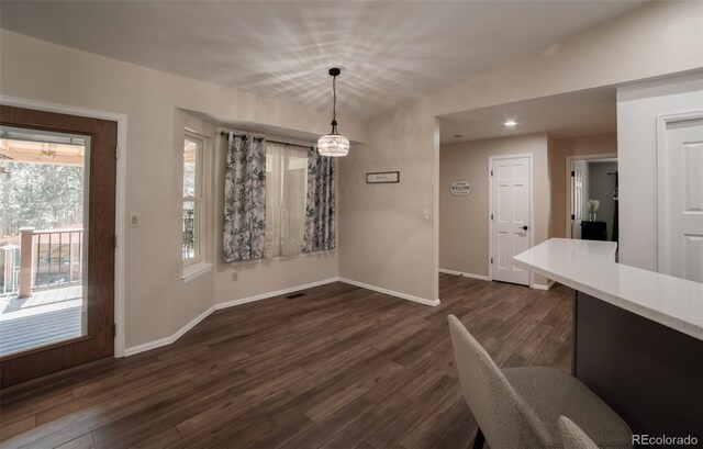 11030 Pine Meadows Rd, Colorado Springs, CO 80908 - unfurnished dining area featuring dark wood-style floors and baseboards
