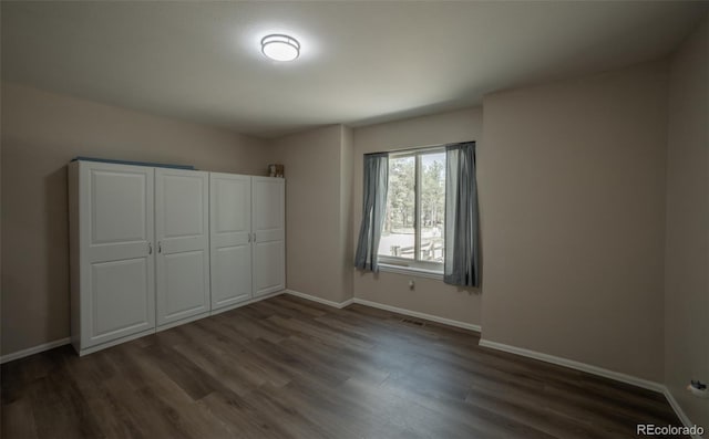 11030 Pine Meadows Rd, Colorado Springs, CO 80908 - unfurnished bedroom featuring dark wood-type flooring and baseboards