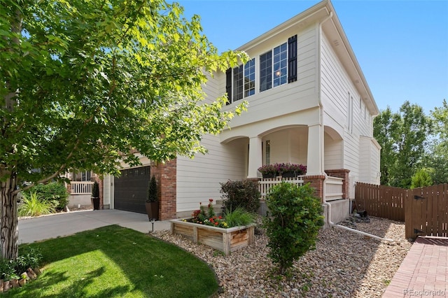 7853 S Jasper Way, Englewood, CO 80112 - view of front of property with brick siding, driveway, a garage, and covered porch