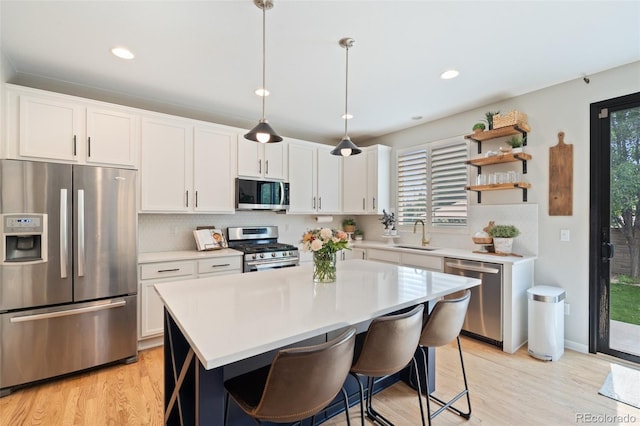 7853 S Jasper Way, Englewood, CO 80112 - kitchen featuring appliances with stainless steel finishes, light countertops, light wood finished floors, white cabinets, and recessed lighting