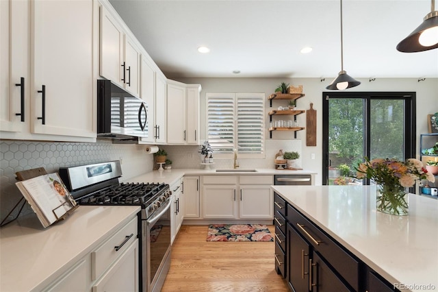 7853 S Jasper Way, Englewood, CO 80112 - kitchen featuring stainless steel appliances, white cabinets, light countertops, recessed lighting, and light wood-style floors