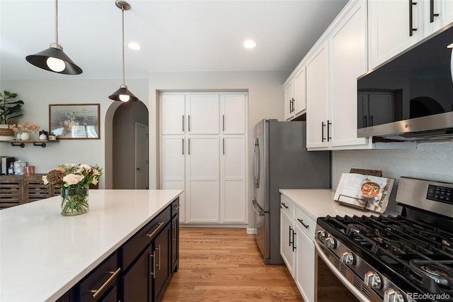 7853 S Jasper Way, Englewood, CO 80112 - kitchen with appliances with stainless steel finishes, white cabinetry, light countertops, hanging light fixtures, and light wood-style floors