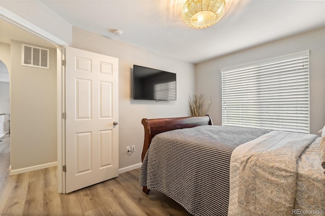 7853 S Jasper Way, Englewood, CO 80112 - bedroom with arched walkways and wood finished floors