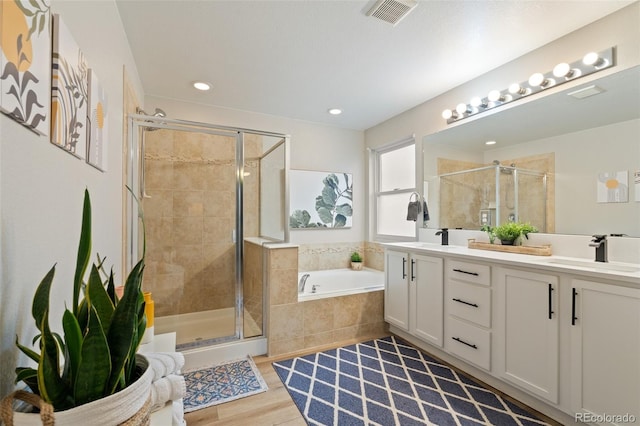 7853 S Jasper Way, Englewood, CO 80112 - bathroom with a stall shower, a garden tub, double vanity, wood finished floors, and recessed lighting