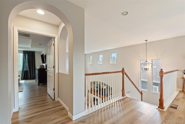 7853 S Jasper Way, Englewood, CO 80112 - hall with an upstairs landing, wood finished floors, a chandelier, and arched walkways