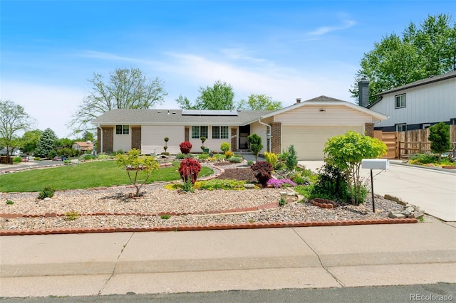 7260 Otis Ct, Arvada, CO 80003 - ranch-style home with brick siding, a garage, solar panels, and concrete driveway