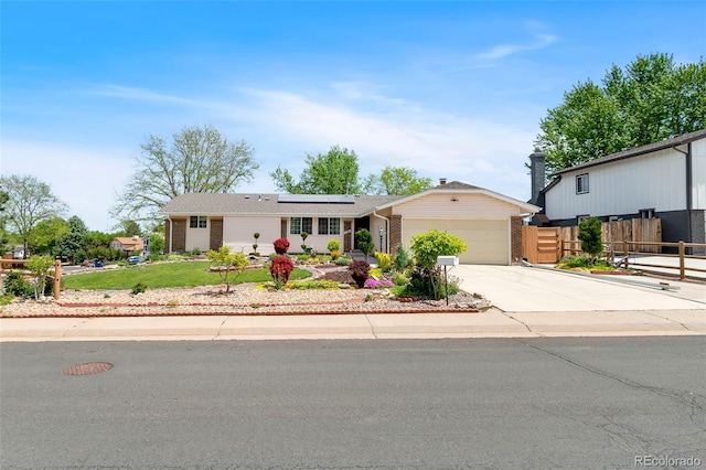 7260 Otis Ct, Arvada, CO 80003 - single story home featuring brick siding, solar panels, driveway, and an attached garage