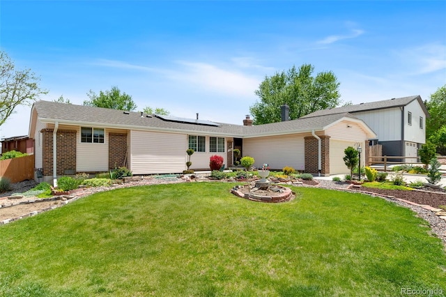 7260 Otis Ct, Arvada, CO 80003 - view of front of house featuring brick siding, a garage, and solar panels