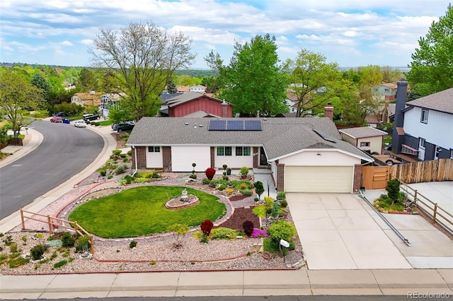 7260 Otis Ct, Arvada, CO 80003 - ranch-style home with brick siding, an attached garage, solar panels, and driveway