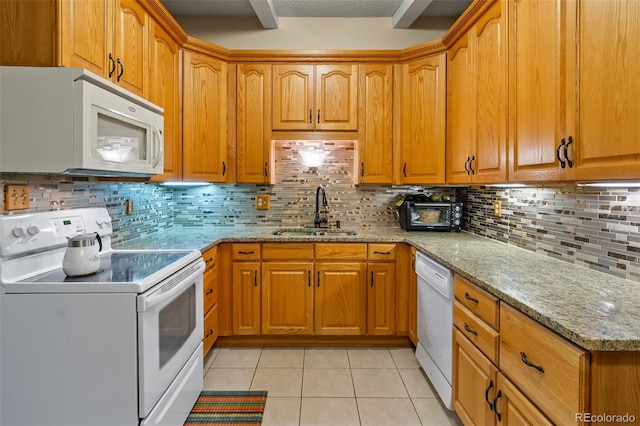 7260 Otis Ct, Arvada, CO 80003 - kitchen featuring white appliances, light stone countertops, light tile patterned flooring, backsplash, and brown cabinetry