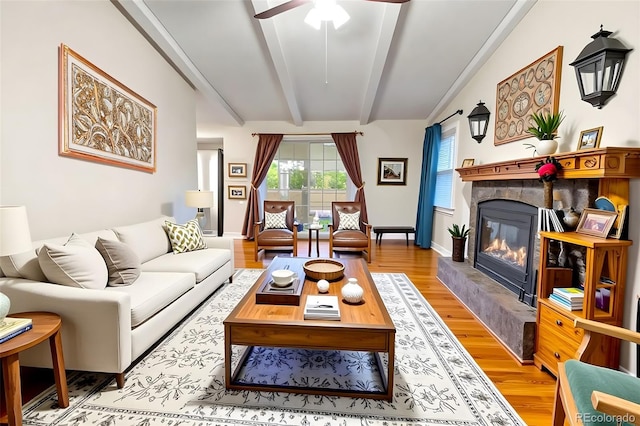 7260 Otis Ct, Arvada, CO 80003 - living room with ceiling fan, a glass covered fireplace, and light wood-type flooring