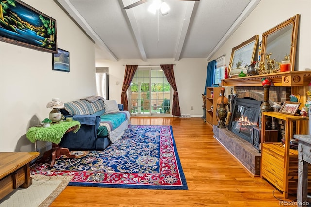 7260 Otis Ct, Arvada, CO 80003 - living area with wood finished floors, ceiling fan, and a glass covered fireplace
