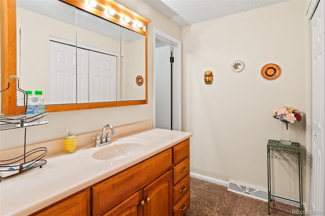 7260 Otis Ct, Arvada, CO 80003 - bathroom featuring vanity and a textured ceiling