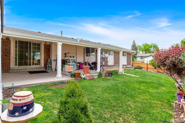 7260 Otis Ct, Arvada, CO 80003 - rear view of house with brick siding and a patio area