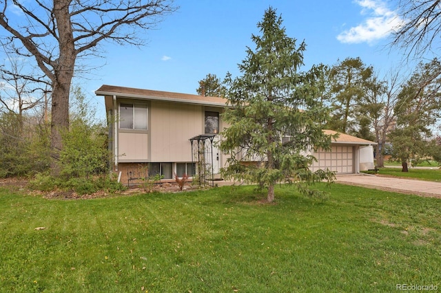 split foyer home with a front lawn, concrete driveway, and a garage