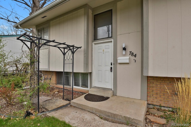 property entrance featuring brick siding