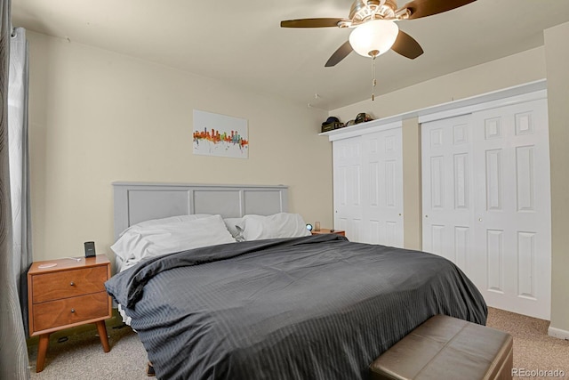 carpeted bedroom with multiple closets and ceiling fan