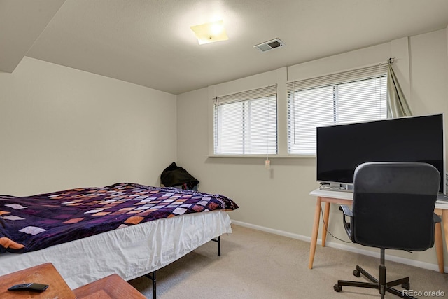carpeted bedroom with baseboards and visible vents
